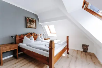 Ein Bett oder Betten in einem Zimmer der Unterkunft Ferienwohnungen am Holstentor