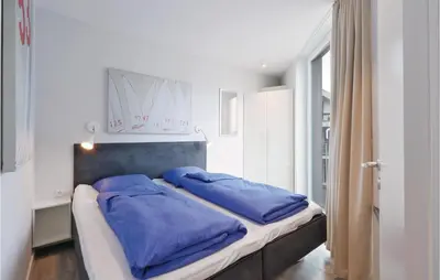 Ein Bett oder Betten in einem Zimmer der Unterkunft Dünenvilla 19, Whg 1