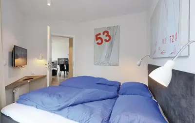 Ein Bett oder Betten in einem Zimmer der Unterkunft Dünenvilla 19, Whg 3
