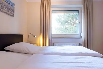Ein Bett oder Betten in einem Zimmer der Unterkunft (DKK1d) Ferienwohnung Seemöwe