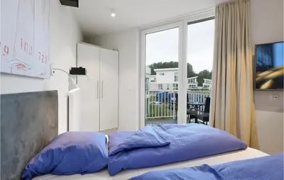 Ein Bett oder Betten in einem Zimmer der Unterkunft Dünenvilla 12, Whg 4
