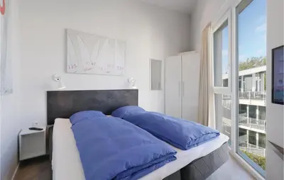 Ein Bett oder Betten in einem Zimmer der Unterkunft Dünenvilla 12, Whg 9