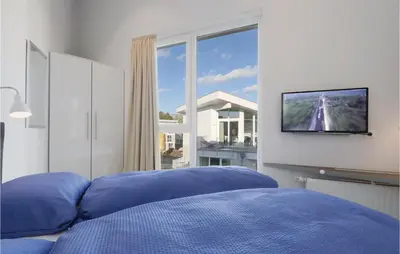 Ein Bett oder Betten in einem Zimmer der Unterkunft Dünenvilla 12, Whg 9