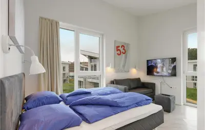 Ein Bett oder Betten in einem Zimmer der Unterkunft Dünenvilla 12, Whg 10