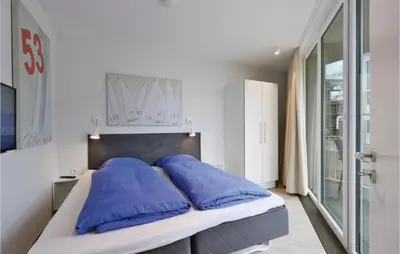 Ein Bett oder Betten in einem Zimmer der Unterkunft Dünenvilla 22, Whg 2
