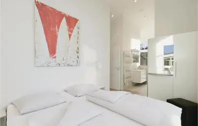 Ein Bett oder Betten in einem Zimmer der Unterkunft Dünenvilla 3, Whg 5