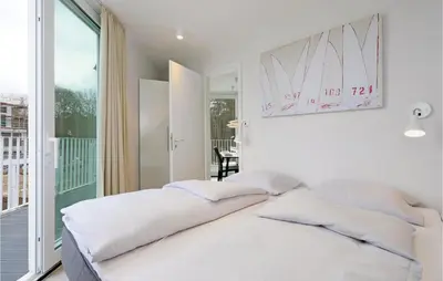 Ein Bett oder Betten in einem Zimmer der Unterkunft Dünenvilla 4, Whg 3