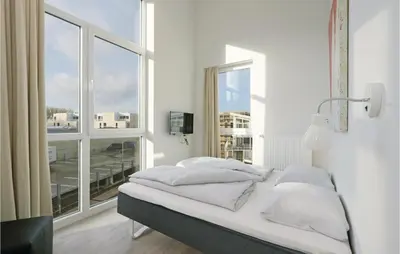 Ein Bett oder Betten in einem Zimmer der Unterkunft Dünenvilla 5, Whg 5