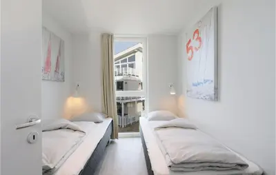 Ein Bett oder Betten in einem Zimmer der Unterkunft Dünenvilla 7, Whg 3