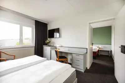 Ein Bett oder Betten in einem Zimmer der Unterkunft Good Morning + Bad Oldesloe