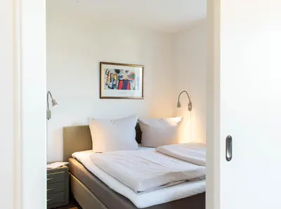 Ein Bett oder Betten in einem Zimmer der Unterkunft Ferienwohnung Lotsenwache