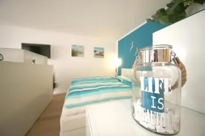 Ein Bett oder Betten in einem Zimmer der Unterkunft Ferienwohnung Strandallee 200