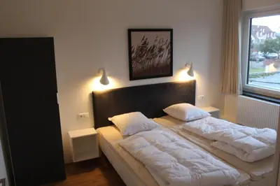Ein Bett oder Betten in einem Zimmer der Unterkunft Dünenhaus Wohnung 7
