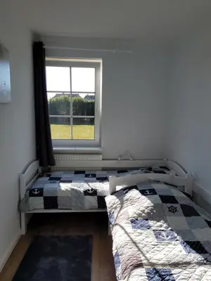 Ein Bett oder Betten in einem Zimmer der Unterkunft Am Pool und Strand 11