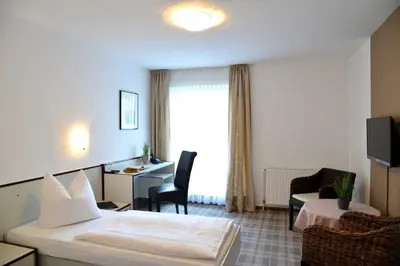 Ein Bett oder Betten in einem Zimmer der Unterkunft Arnimsruh Hotel garni