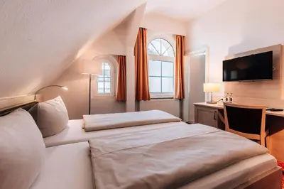 Ein Bett oder Betten in einem Zimmer der Unterkunft Hotel Gorch Fock