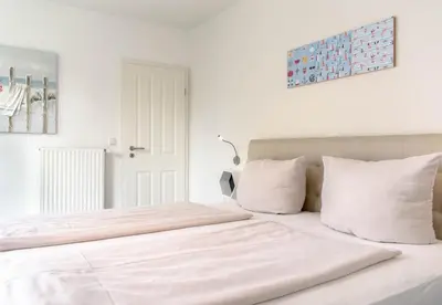 Ein Bett oder Betten in einem Zimmer der Unterkunft Ferienwohnung Reede 54
