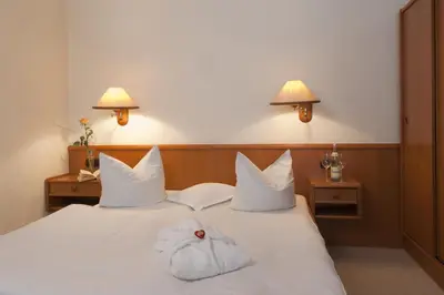 Ein Bett oder Betten in einem Zimmer der Unterkunft Hotel Parkfrieden