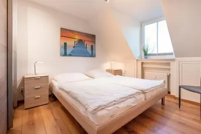 Ein Bett oder Betten in einem Zimmer der Unterkunft Ferienhaus Bergstraße 62 Appartement Heimathafen