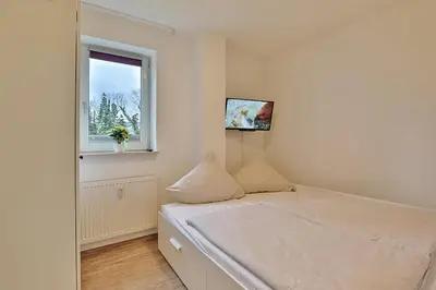 Ein Bett oder Betten in einem Zimmer der Unterkunft Wohnpark am Mühlenteich Wohnpark am Mühlenteich Appartement 32