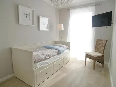 Ein Bett oder Betten in einem Zimmer der Unterkunft Strandglück Haus A Strandglück Appartement 7A