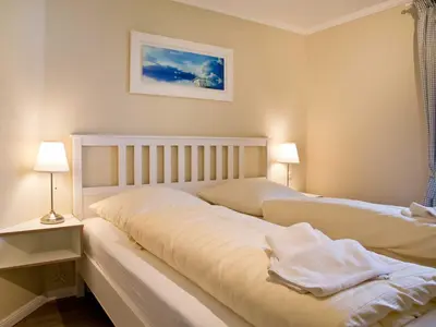 Ein Bett oder Betten in einem Zimmer der Unterkunft TRA7c Ferienwohnung Kossmann