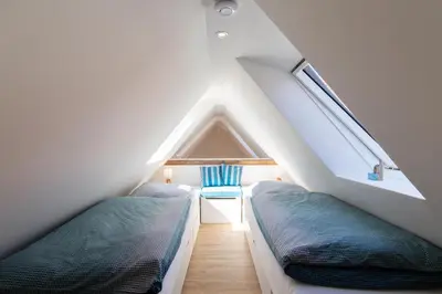 Ein Bett oder Betten in einem Zimmer der Unterkunft Ferienwohnung Nordic Nature Loft in Travemünde direkt in der Vorderreihe inkl Privatsauna