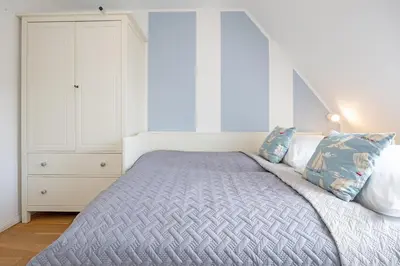 Ein Bett oder Betten in einem Zimmer der Unterkunft Strandallee 128- Seesternchen
