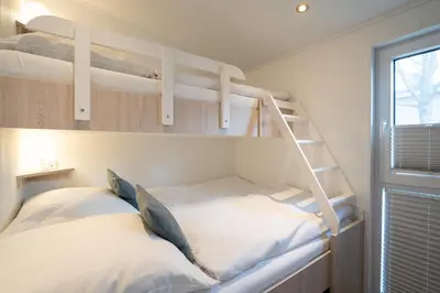 Ein Bett oder Betten in einem Zimmer der Unterkunft Ostseecamp Lübecker Bucht Ferienhaus 