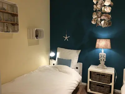 Ein Bett oder Betten in einem Zimmer der Unterkunft Strandappartment Meerkieker