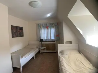 Ein Bett oder Betten in einem Zimmer der Unterkunft Top Lage! Charmantes Landhaus 5 Geh-Min v. Strand