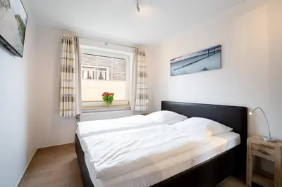 Ein Bett oder Betten in einem Zimmer der Unterkunft DKK5 Ferienwohnung Ostseeperle