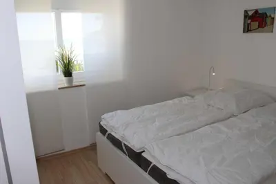 Ein Bett oder Betten in einem Zimmer der Unterkunft STR123f Ferienwohnung Braun