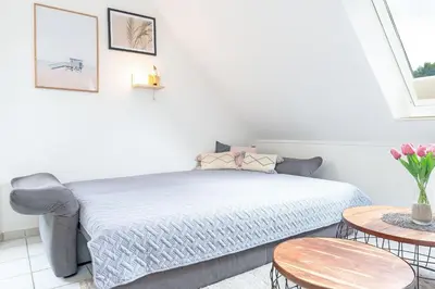 Ein Bett oder Betten in einem Zimmer der Unterkunft Haus Pegasus Küstenliebe