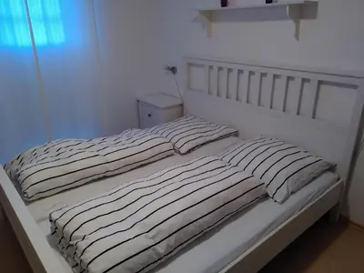 Ein Bett oder Betten in einem Zimmer der Unterkunft Ferienwohnung Strandnest Sierksdorf